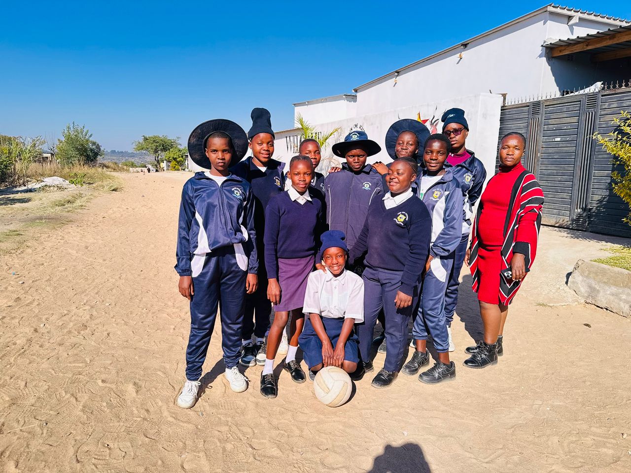Twin One Academy student sports team with a ball