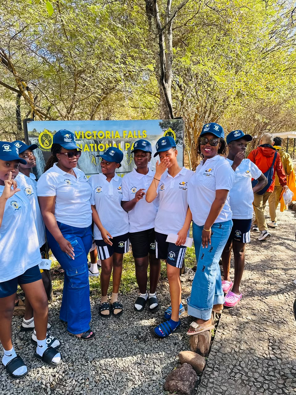 Learners and staff at the Victoria Falls National Park sign