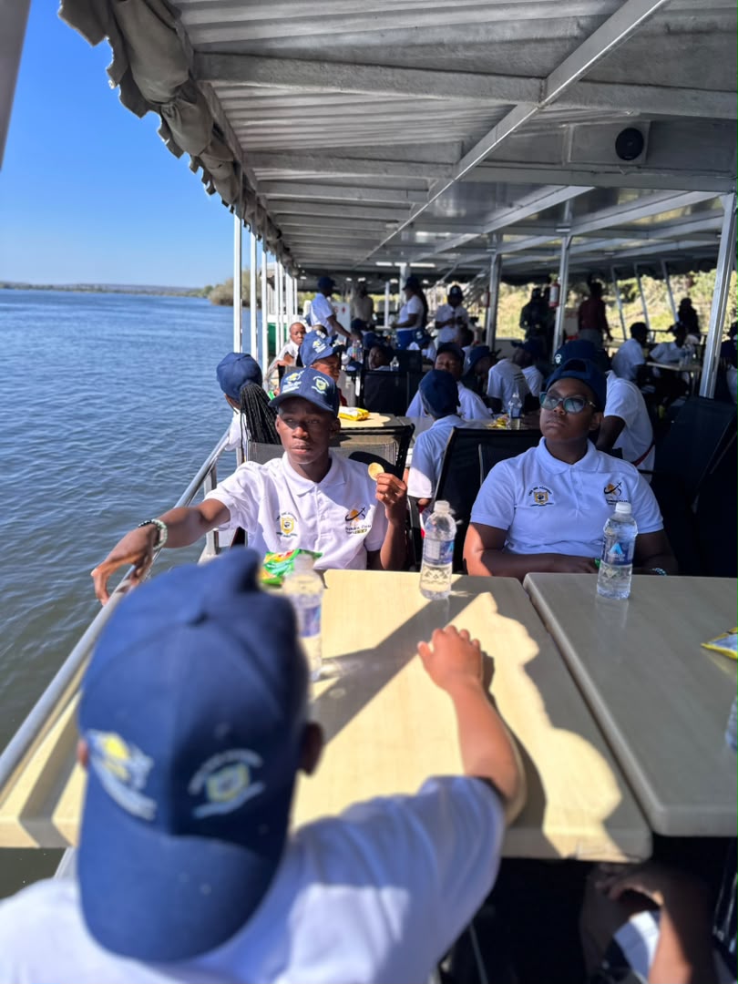 Learners seated on a river cruise during the Victoria Falls trip